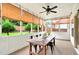 Bright sunroom featuring a dining table, ceiling fan, and windows providing natural light and views of the backyard at 3975 Silverthorn Trce, Cumming, GA 30028