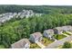 Aerial view of a neighborhood with lush green trees surrounding well-maintained homes at 6065 Crescent Landing Dr, Cumming, GA 30028