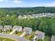 New construction homes in a neighborhood surrounded by mature trees on a sunny day at 6065 Crescent Landing Dr, Cumming, GA 30028