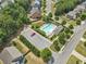 Aerial view of community pool and parking, surrounded by trees and well-maintained landscaping at 6065 Crescent Landing Dr, Cumming, GA 30028