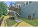 Multi-level wooden deck in a lush backyard, perfect for outdoor relaxation and enjoying nature at 6065 Crescent Landing Dr, Cumming, GA 30028