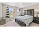 Bedroom featuring carpet flooring, two windows with striped curtains and dark wood furniture at 6065 Crescent Landing Dr, Cumming, GA 30028