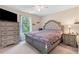 Cozy bedroom with carpet, a decorative ceiling fan, and large windows with a view to the backyard at 6065 Crescent Landing Dr, Cumming, GA 30028