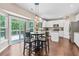 Bright eat-in kitchen with white cabinets, stainless appliances, and views of a spacious deck at 6065 Crescent Landing Dr, Cumming, GA 30028