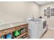 Laundry area featuring a countertop for folding and a modern washer and dryer set at 6065 Crescent Landing Dr, Cumming, GA 30028