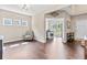 Bright living room with wood floors, neutral paint, and multiple windows offers lots of natural light at 6065 Crescent Landing Dr, Cumming, GA 30028