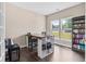 Home office setup features desk, chair, and windows overlooking the front yard with room for book storage at 6065 Crescent Landing Dr, Cumming, GA 30028