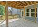 Covered wooden patio area with railing, providing an ideal space for outdoor dining and entertainment at 6065 Crescent Landing Dr, Cumming, GA 30028