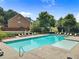 Community pool with lounge chairs for residents on a sunny summer day at 6065 Crescent Landing Dr, Cumming, GA 30028