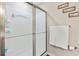 Frosted glass shower with silver trim and towel rack at 6065 Crescent Landing Dr, Cumming, GA 30028