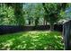 Spacious backyard featuring lush green grass and a tall wooden privacy fence at 905 Gaston Sw St, Atlanta, GA 30310