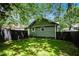 Green house backyard with privacy fence and lush grass at 905 Gaston Sw St, Atlanta, GA 30310