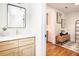 Stylish bathroom featuring a vanity with white countertop, wood cabinets, and a decorative mirror at 905 Gaston Sw St, Atlanta, GA 30310
