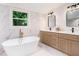 Modern bathroom featuring a soaking tub, double vanity, and sleek fixtures for a spa-like experience at 905 Gaston Sw St, Atlanta, GA 30310