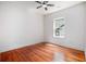 Sunlit bedroom with hardwood floors, ceiling fan and a large window at 905 Gaston Sw St, Atlanta, GA 30310