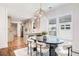 Chic dining room features a modern table and chairs with a modern chandelier adjacent to the updated kitchen at 905 Gaston Sw St, Atlanta, GA 30310