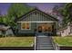 Charming craftsman-style home featuring a large front porch, green siding, and a well-maintained front yard at 905 Gaston Sw St, Atlanta, GA 30310