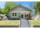 Charming craftsman-style home featuring a large front porch, green siding, and a well-maintained front yard at 905 Gaston Sw St, Atlanta, GA 30310