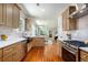 Well-lit kitchen showcasing an open layout leading to the dining and living area with updated appliances and sink at 905 Gaston Sw St, Atlanta, GA 30310