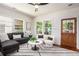 Bright living room with sectional sofa, swivel chairs, natural light, and hardwood floors at 905 Gaston Sw St, Atlanta, GA 30310