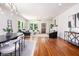Open concept living room and dining area with hardwood floors, modern furnishings, and ample natural light at 905 Gaston Sw St, Atlanta, GA 30310