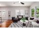 Bright living room with sectional sofa, swivel chairs, natural light, and hardwood floors at 905 Gaston Sw St, Atlanta, GA 30310