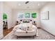 Cozy main bedroom featuring hardwood floors, large windows, and stylish furnishings, perfect for relaxation at 905 Gaston Sw St, Atlanta, GA 30310