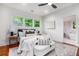 Comfortable main bedroom with large windows, ceiling fan, and hardwood floors, adjacent to the main bathroom at 905 Gaston Sw St, Atlanta, GA 30310