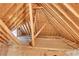 Unfinished attic space with exposed wooden beams and plywood flooring at 26 Trillium Ln, Acworth, GA 30101