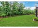 Lush backyard with mature trees and wooden fence, creating a private outdoor space at 26 Trillium Ln, Acworth, GA 30101