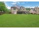 Expansive backyard with lush green grass, a multi-level deck, and mature trees at 26 Trillium Ln, Acworth, GA 30101