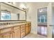 Well-lit bathroom featuring a double sink vanity with granite countertops and wood cabinets at 26 Trillium Ln, Acworth, GA 30101