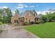Beautiful home featuring brick exterior, three-car garage, and a well-manicured lawn at 26 Trillium Ln, Acworth, GA 30101