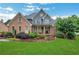 Inviting two-story home with a brick facade, manicured landscaping, and lush green lawn on a sunny day at 26 Trillium Ln, Acworth, GA 30101