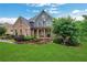 Inviting two-story home with a brick facade, manicured landscaping, and lush green lawn at 26 Trillium Ln, Acworth, GA 30101