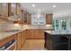 The kitchen has a gas range, granite countertops, stainless appliances and an island at 26 Trillium Ln, Acworth, GA 30101
