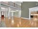A well-lit living area featuring a grand fireplace, wood floors, and a view into the kitchen at 26 Trillium Ln, Acworth, GA 30101