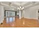 Expansive living room showcasing hardwood floors, white columns, fireplace, and coffered ceilings at 26 Trillium Ln, Acworth, GA 30101