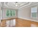 Spacious main bedroom with hardwood floors, tray ceiling, and windows at 26 Trillium Ln, Acworth, GA 30101