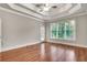 Main bedroom with hardwood floors, tray ceiling, and backyard access at 26 Trillium Ln, Acworth, GA 30101