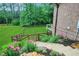 Charming backyard with stone steps, flower beds, and lush green lawn at 26 Trillium Ln, Acworth, GA 30101
