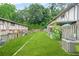 Wide shot of backyard with green grass and gardening beds for the home at 2952 N Dekalb Dr # C, Atlanta, GA 30340