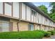 Traditional townhome featuring a brick facade and well-maintained landscaping with trimmed hedges at 2952 N Dekalb Dr # C, Atlanta, GA 30340
