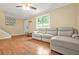 Cozy living room with wood floors, a comfortable leather sofa, and plenty of natural light at 2952 N Dekalb Dr # C, Atlanta, GA 30340