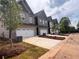 Row of new construction townhomes with brick and siding exteriors, two-car garages, and freshly installed landscaping at 3106 Marbella Cir # 3, Kennesaw, GA 30152