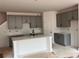 The kitchen features an island, grey cabinets and light countertops at 3106 Marbella Cir # 3, Kennesaw, GA 30152