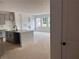 Open concept kitchen view shows the large island, gray cabinets, and connection to the living room at 3106 Marbella Cir # 3, Kennesaw, GA 30152