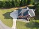 Aerial view of a two-story home with a well-maintained yard, driveway, and mature trees at 3898 Heritage Oaks Dr, Powder Springs, GA 30127
