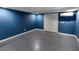 Unfinished basement features painted walls, concrete flooring, and convenient access doors at 3898 Heritage Oaks Dr, Powder Springs, GA 30127