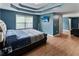 Large bedroom with wood floors, tray ceiling, and a flat-screen TV at 3898 Heritage Oaks Dr, Powder Springs, GA 30127